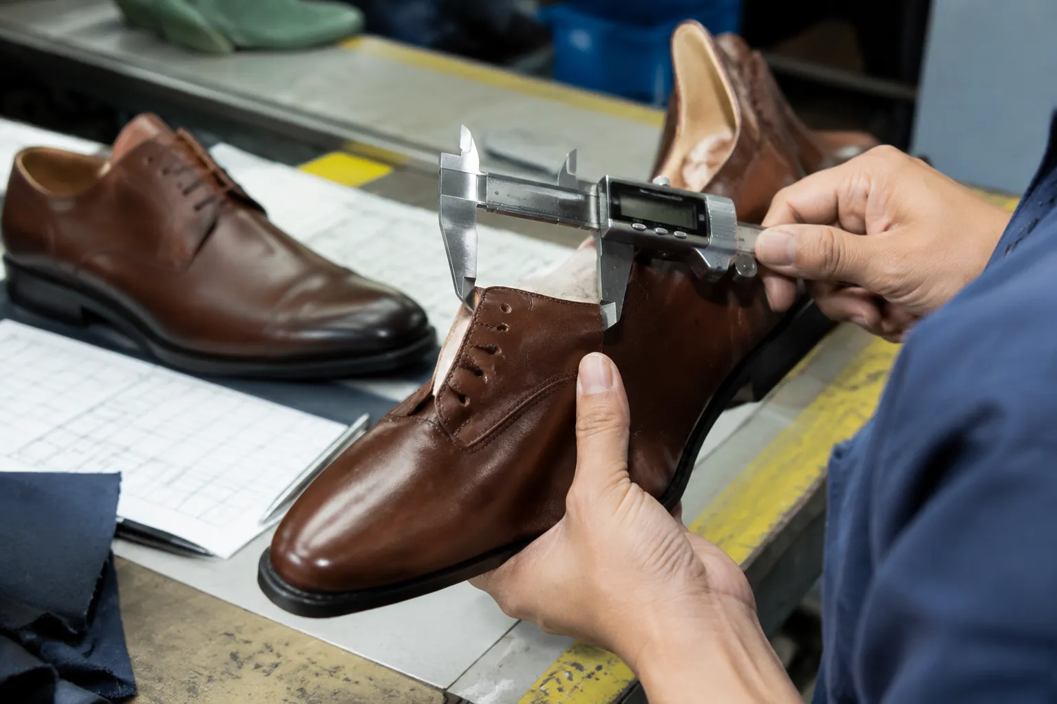 Inspector using a caliper during an AQL leather shoe inspection